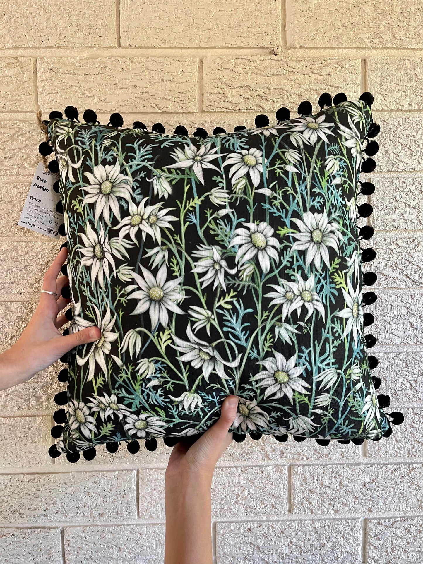 Flannel Flower Pom Pom Cushion on Black