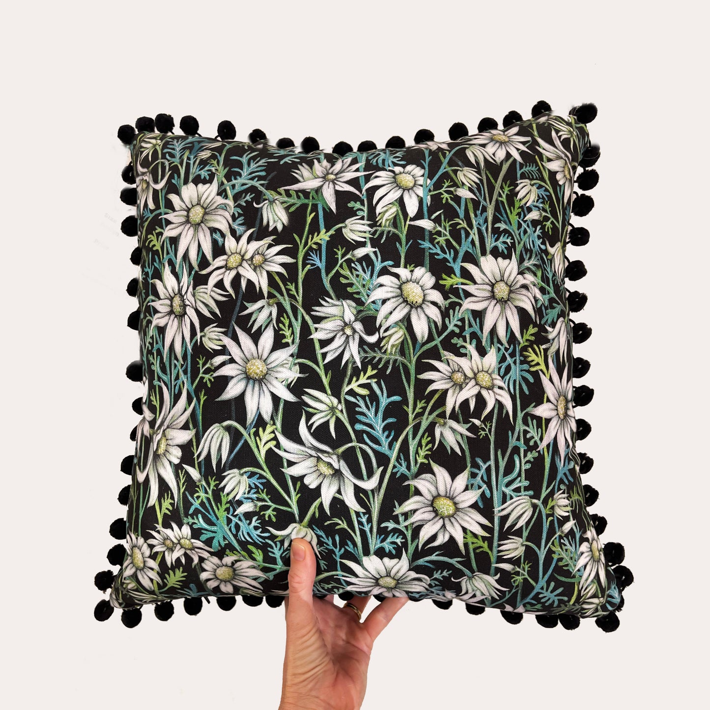 Flannel Flower Pom Pom Cushion on Black